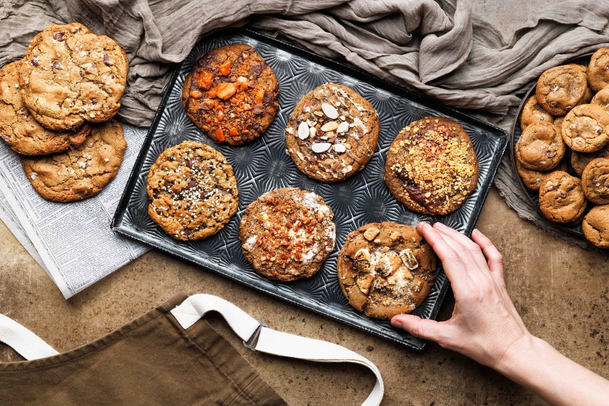 Tray of Magnolia gourmet cookies including Peanut Butter Butterfinger, Earl Grey fig almond, Tahini Oat and S'mores, with salted brown butter chocolate chip cookies and minis
