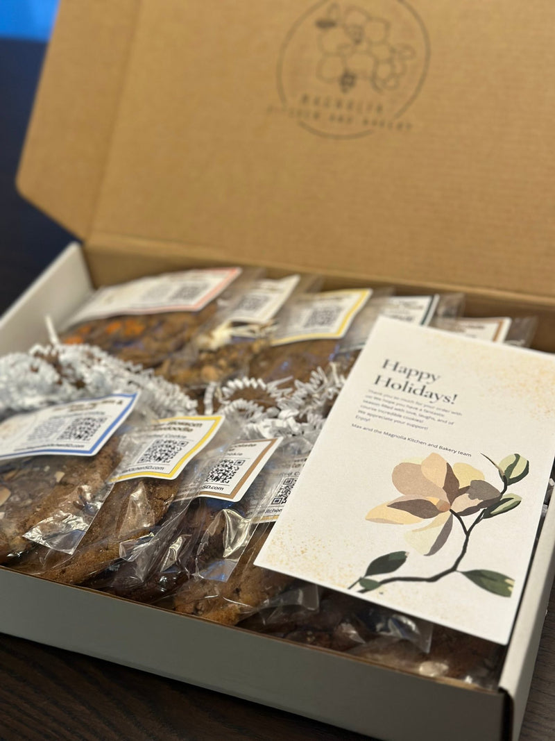 Magnolia holiday corporate cookie gift box with assorted wrapped cookies and a holiday card
